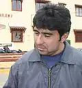 A crestfallen man wearing a blue jacket