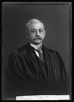 Black-and-white portrait of George W. Atkinson wearing glasses and a judicial robe, facing slightly left.