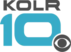 Gray wide letters KOLR above a teal, somewhat futuristic 10 with squarish sides. The CBS eye in gray overlaps the 0 in the lower right with a white cutout.
