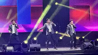 A wide angle shot of musicians performing onstage