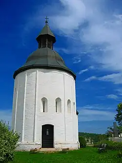 A small round church with five windows and a gate