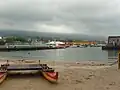 The small beach is protected by the pier.