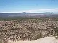 Tent rocks, with Cochiti Pueblo lands and the Rio Grande in the distance