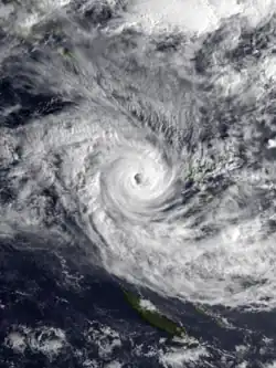Composite satellite image of Cyclone Katrina west of Vanuatu. The cyclone has dense and spiraling clouds forming a defined eye in the storm's center.