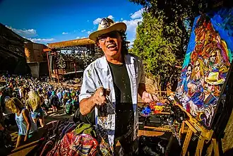 Scramble Campbell painting live at Red Rocks during a Grant Farm concert