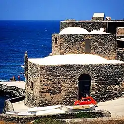 Stone buildings on a street along the island's rocky coast
