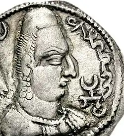 Khingila with the word "Alchono" in Bactrian script (αλχονο) and the Tamgha symbol on his coins.[156][157]