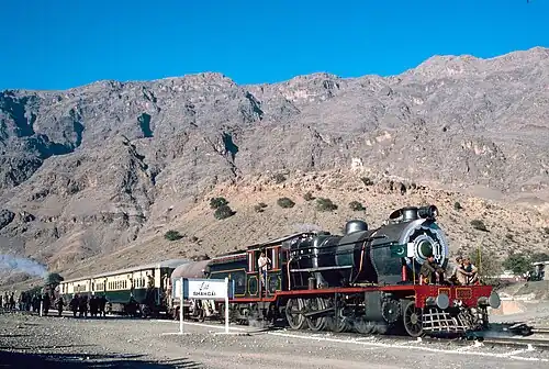 Train against mountains and a blue sky