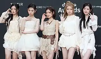 The five members of KiiiKiii at a photocall for a brand