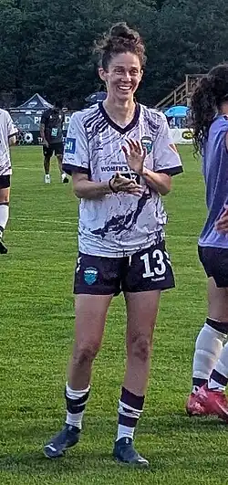 Player in uniform clapping and smiling