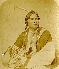 A colorless portrait photograph of an Ojibwe man at half length.