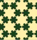 Tessellation by two sizes of Koch snowflake