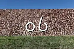 The Kokernot Ranch "o6" brand on a rock wall at Kokernot Field