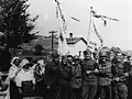 Cheerful German and Slovak soldiers posing with Ukrainian civilians in Komańcza, Poland, in 1939