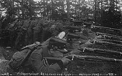 Norwegian soldiers lying prone, armed with rifles.