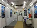 The interior of car 01-136 with wheelchair space in May 2015