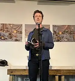 Kunz reading at The Peckham Pelican in London, UK, in 2023.