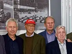Kurt Bergmann, Niki Lauda, Marko, and Erich Breinsberg smile for a photograph in 2009