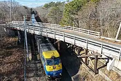 Train passing beneath the closed Cranberry Hole Road Bridge in Amagansett
