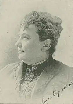 19th-century B&W portrait photo of a woman with her hair in an up-do, wearing a dark, fitted blouse.