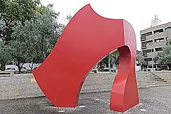 A red, cape-shaped sculpture