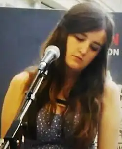Aquilina performing in Kings Cross, London in May 2013