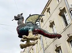 Model of Graoully hung between buildings in Metz