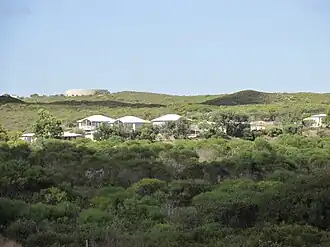 Looking west from Ledge Point over surrounding bushland and water tank, 2015