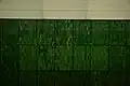 The original underground green side wall tiling and station name reminding of forests