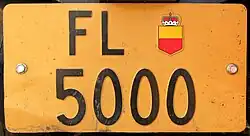 Light brown Liechtenstein license plate for exceptional vehicles and trailers, trailers display a single plate numbered above 5000.