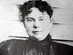 Black-and-white head and shoulders photograph of a woman looking at the camera