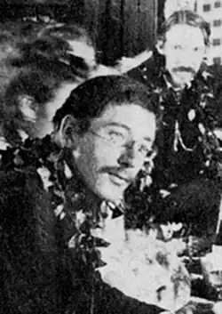 Osbourne (left) and his stepfather, Robert Louis Stevenson (right), attending a Royal Luau thrown by King Kalākaua, Honolulu, Hawaii, c. 1889