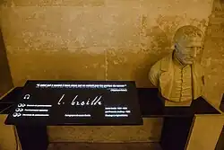 A stone bust of Braille with an audiotronic memorial plaque