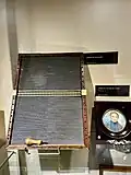 Washboard slate with a removable, two line braille slate. Miniature painting on Ivory by Lucienne Filippi