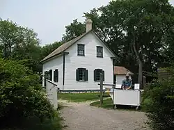 Exterior view of Riel House showing its west-facing façade and log construction in St. Vital, Winnipeg