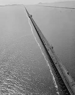 Aerial view of the Lucin Cutoff railway trestle in Utah, U.S.A., before removal. The 1950s causeway is visible to its right.
