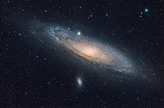 A visible light image of the Andromeda Galaxy and two satellite galaxies. Messier 32 is above the galactic nucleus and Messier 110 is at the bottom.