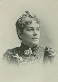 B&W portrait photo of a middle-aged woman with her hair in an up-do.