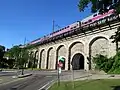An MBTA commuter rail train passes over the Neponset Street underpass