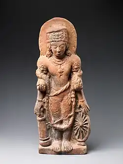 A statue of Vishnu Caturanana ("Four-Armed"), using the attributes of Vāsudeva, with the addition of an aureole around the head (5th century CE)[36]