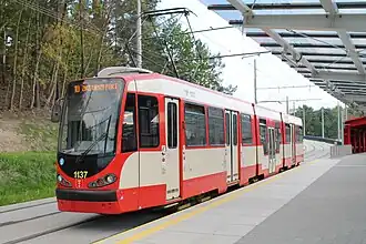 Three-section tram, the door in the centre section is lower than those in the end sections.