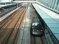 A Tung Chung line CAF-train at Sunny Bay station viewed from a footbridge