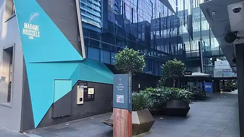Entry to a city laneway, with a sign reading "Madame Brussels Lane"