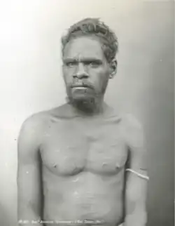 Portrait photograph of a shirtless Aboriginal man