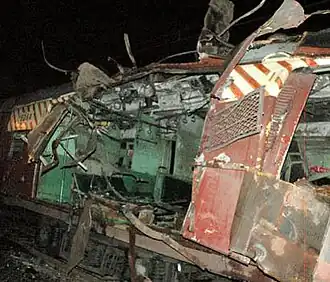 A color photograph of a railway coach blown apart from the middle