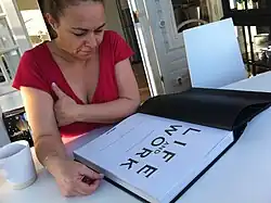 Malene Birger sitting reading Life and Work in 2011