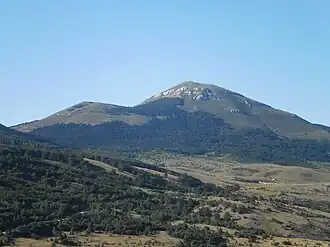 A green mountain with two peaks