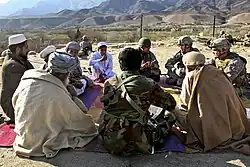 US Army Psyops personnel meet with village elders from Mangow village in Laghman province