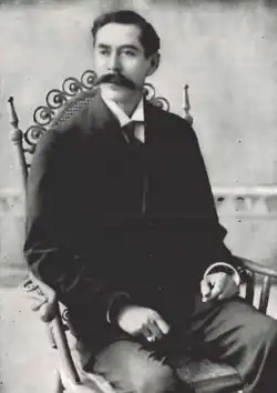 A black-and-white photograph of Manuel Enrique Araujo sitting