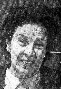 A black and white photo of a smiling woman's face